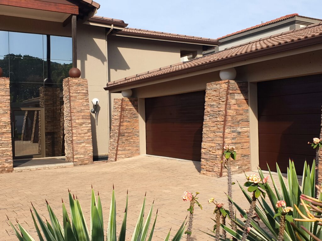 Slatted chocolate-brown fibreglass garage doors by Quality Design Doors